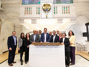 rogers leadership team underneath nyse closing bell